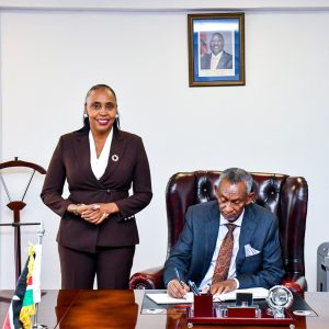 Ambassador Mahboub Maalim signs the visitor register alongside PS Caroline Karugu during a consultative meeting on Equalisation Fund strategy in Nairobi.